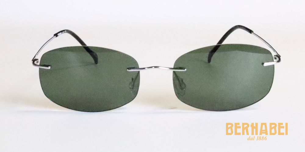 Occhiali da sole con lenti rettangolari verde scuro e struttura in titanio